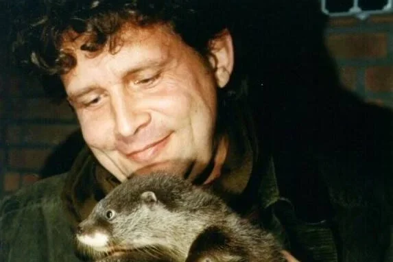 Photo of Stichting Otterstation Nederland founder Addy de Jongh with three otters
