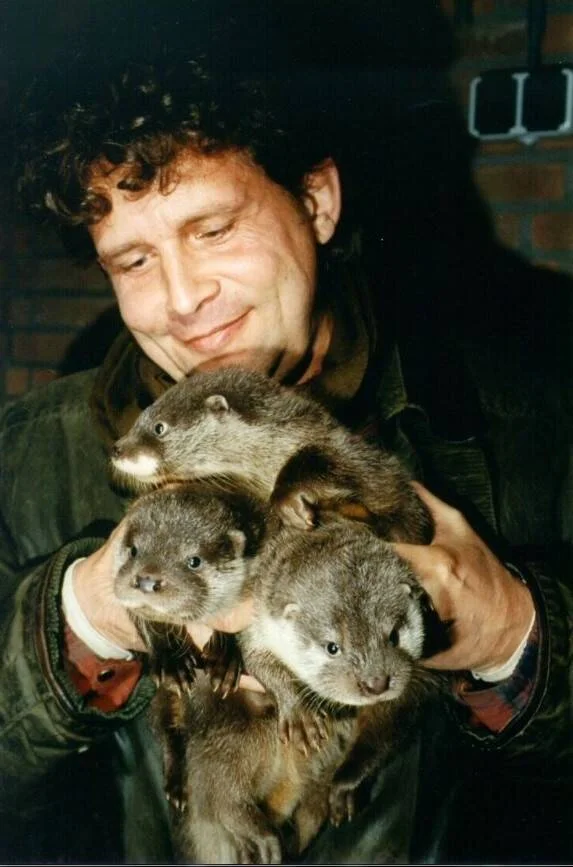 Photo of Stichting Otterstation Nederland founder Addy de Jongh with three otters