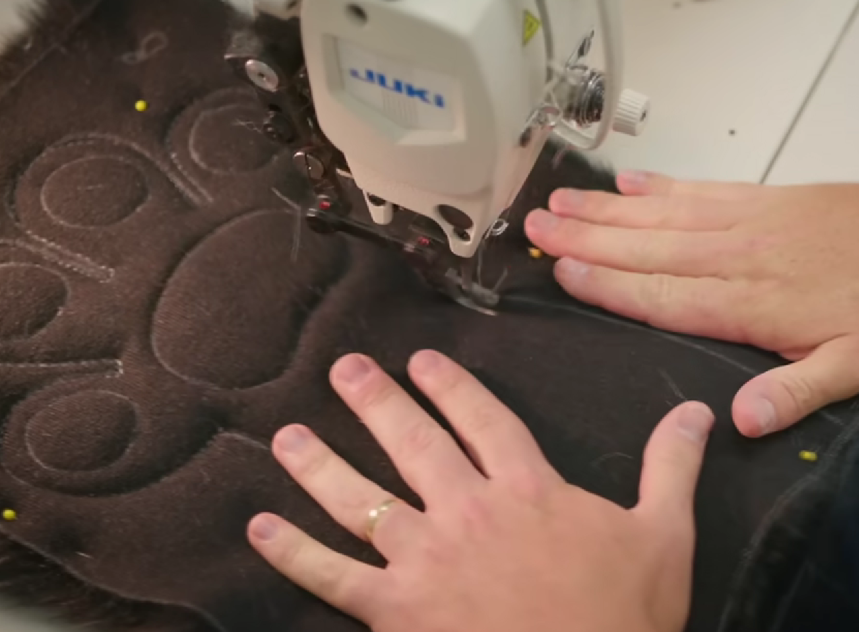 Photo of someone sewing a paw