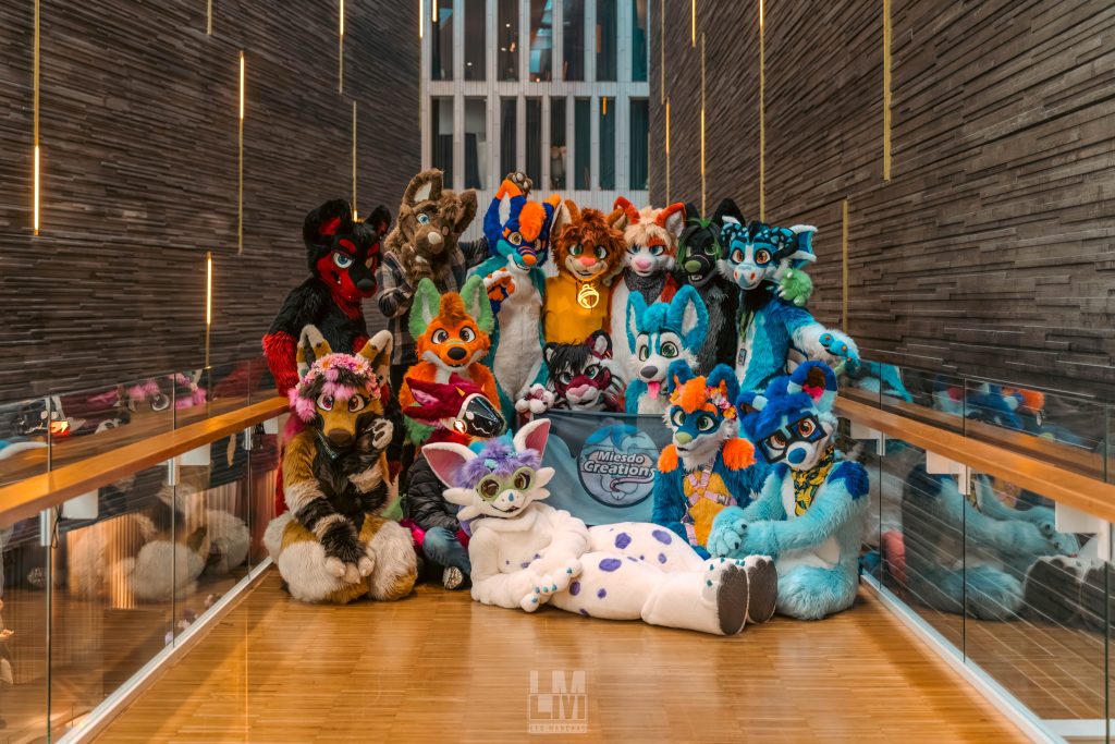 A photo of several of Miesdocreations' fursuits being modeled in a hallway.